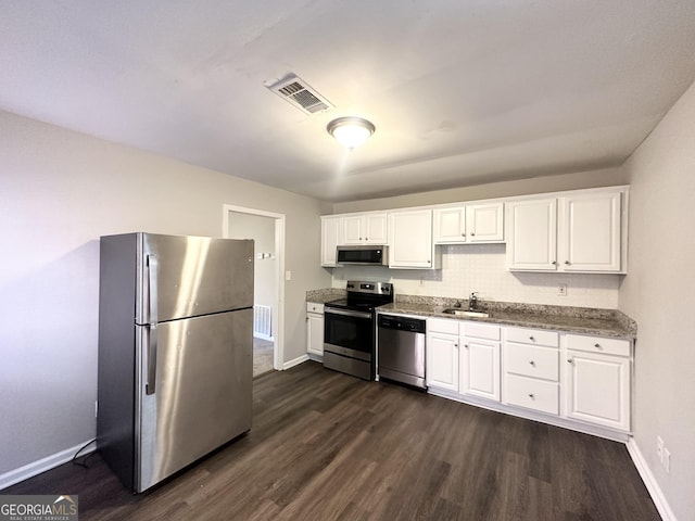 kitchen featuring dark hardwood / wood-style flooring, white cabinets, stainless steel appliances, and sink