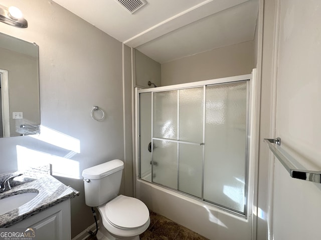 full bathroom featuring tile patterned floors, vanity, toilet, and bath / shower combo with glass door