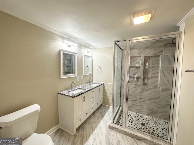 bathroom featuring toilet, a shower with shower door, and ornamental molding