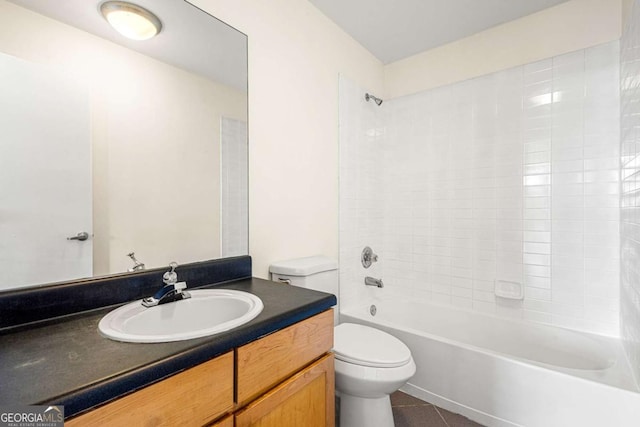 full bathroom featuring toilet, vanity, tiled shower / bath combo, and tile patterned floors