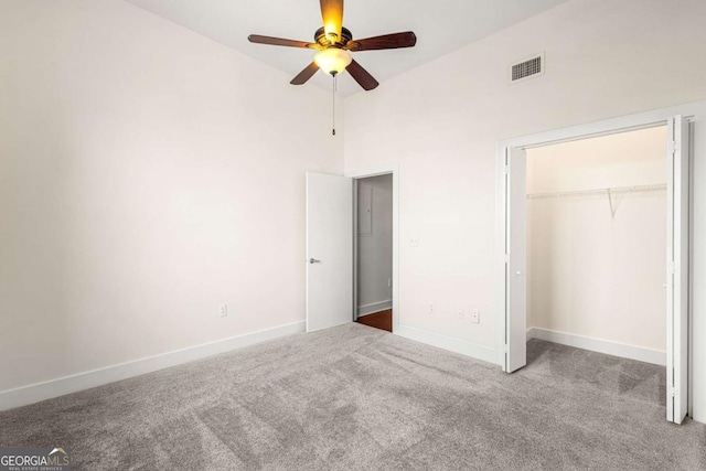 unfurnished bedroom featuring carpet flooring, ceiling fan, high vaulted ceiling, and a closet