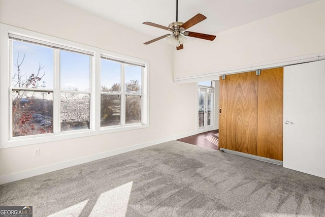 interior space featuring ceiling fan and carpet floors