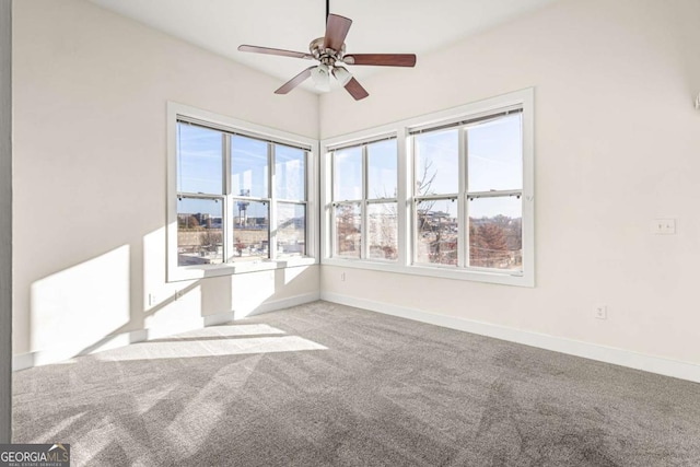 unfurnished room with ceiling fan and light carpet