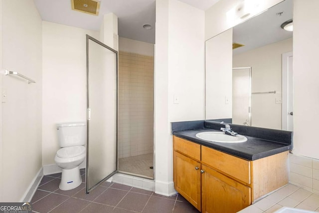 bathroom with tile patterned floors, vanity, toilet, and an enclosed shower