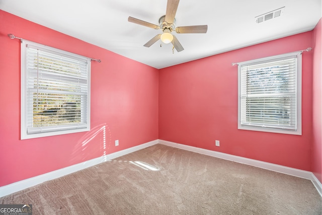 carpeted spare room with ceiling fan