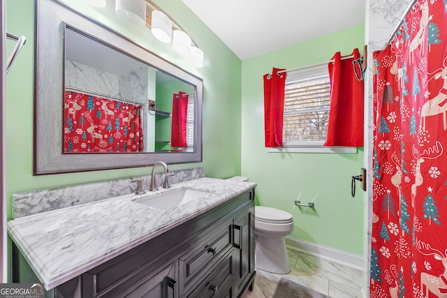 bathroom with curtained shower, vanity, and toilet