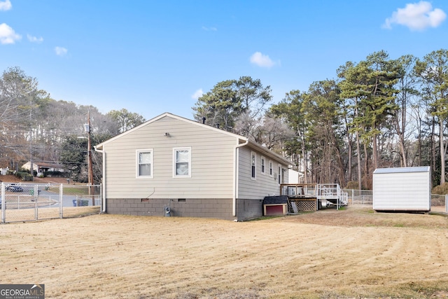 view of home's exterior featuring a shed and a deck