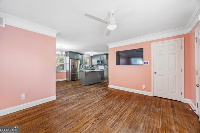 unfurnished living room with ceiling fan with notable chandelier, dark hardwood / wood-style flooring, and crown molding