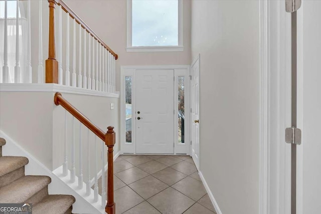 tiled foyer entrance with a high ceiling