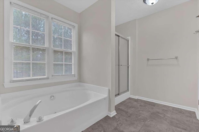 bathroom with separate shower and tub and a wealth of natural light