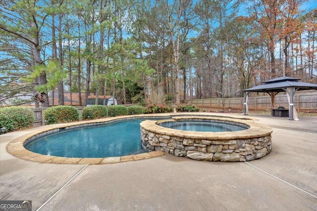 view of pool with a gazebo, an in ground hot tub, and a patio