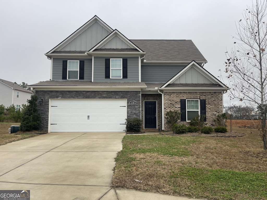 view of front of property with a garage and a front lawn