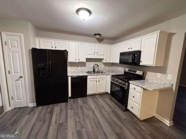 kitchen with dark hardwood / wood-style flooring, sink, white cabinetry, and black appliances