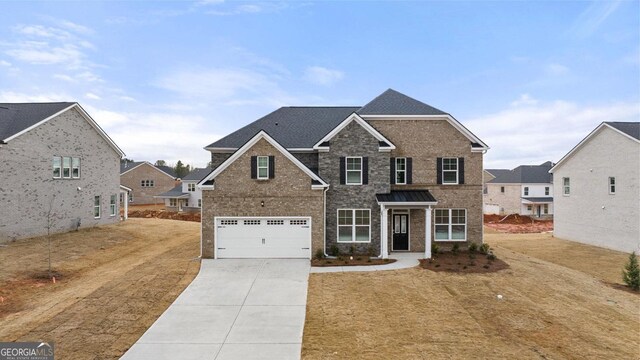 view of front facade featuring a front yard and a garage