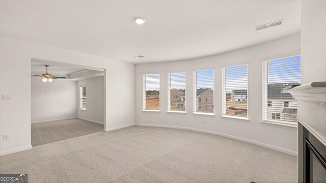 unfurnished living room with light carpet and ceiling fan