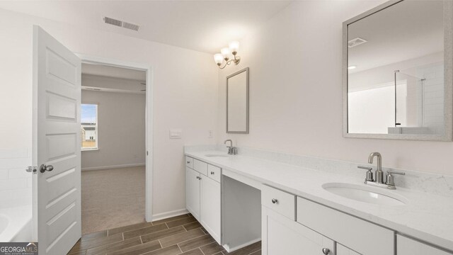 bathroom with hardwood / wood-style floors, vanity, and walk in shower