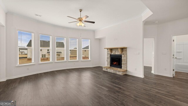 unfurnished living room featuring a fireplace, dark hardwood / wood-style flooring, ceiling fan, and ornamental molding