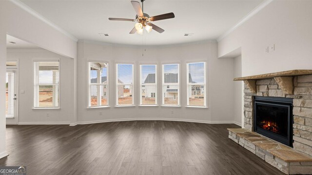 unfurnished living room with a fireplace, ceiling fan, ornamental molding, and dark wood-type flooring