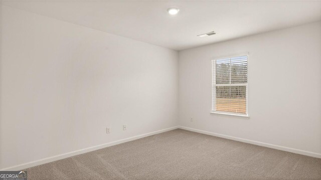 spare room featuring carpet floors