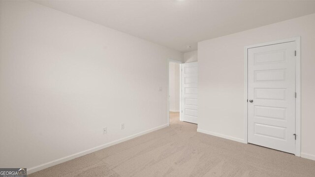 unfurnished bedroom featuring light colored carpet