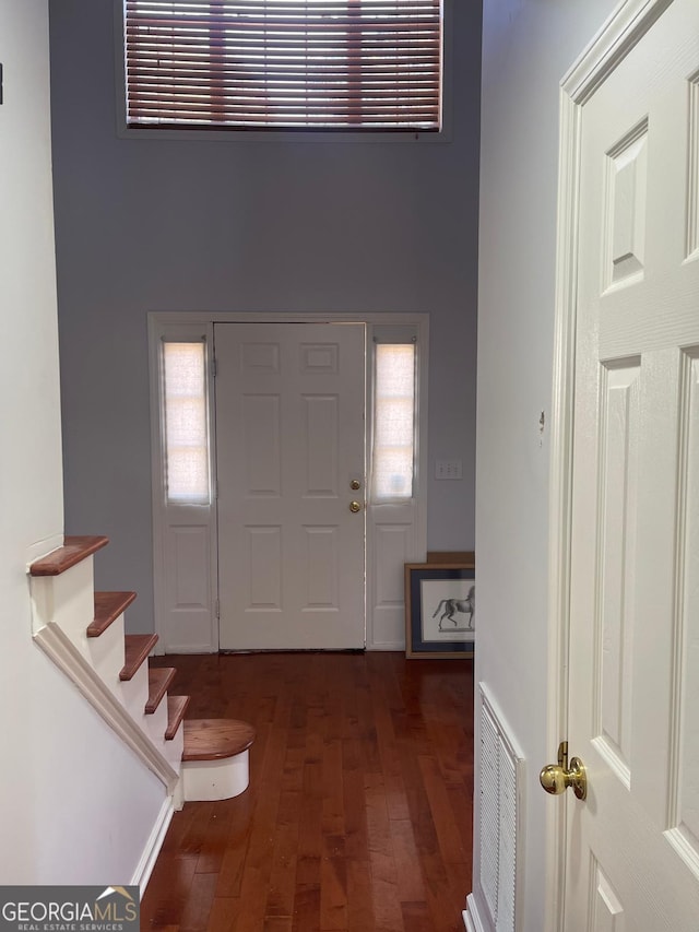 entrance foyer with dark hardwood / wood-style floors