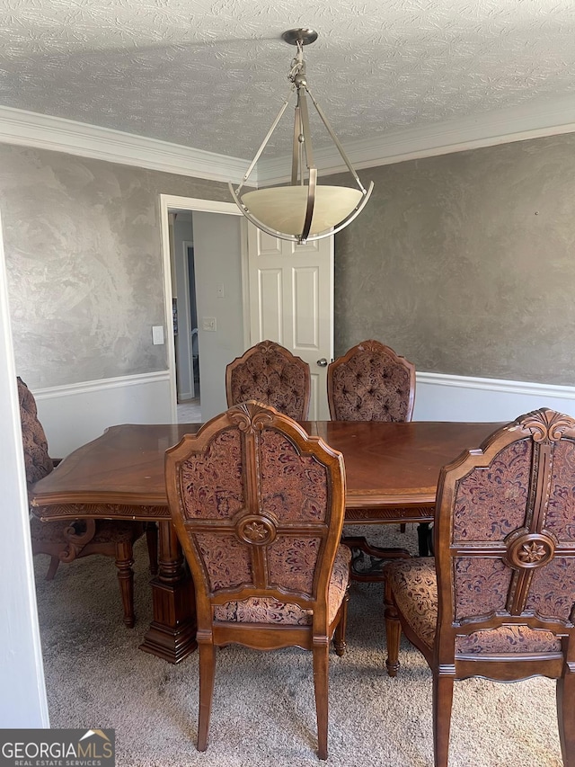 dining room with a textured ceiling and ornamental molding