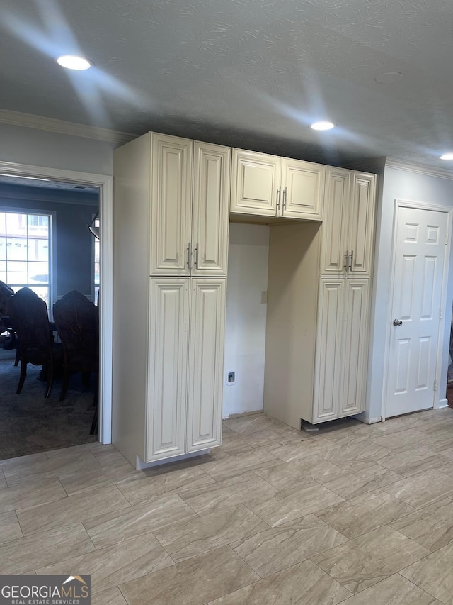 kitchen featuring cream cabinetry and ornamental molding