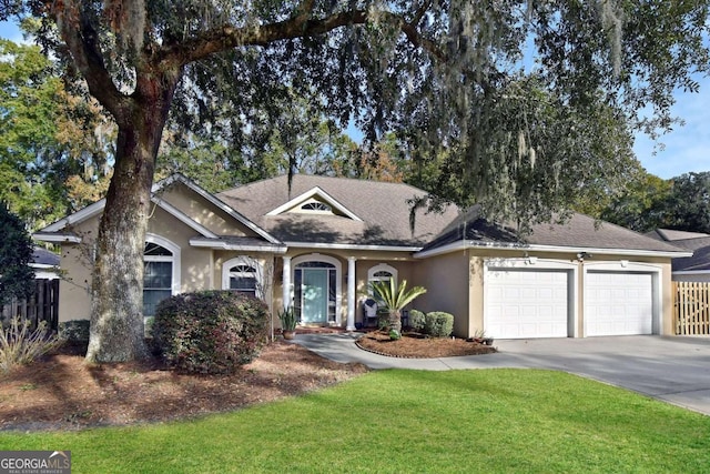 view of front of home featuring a front yard and a garage