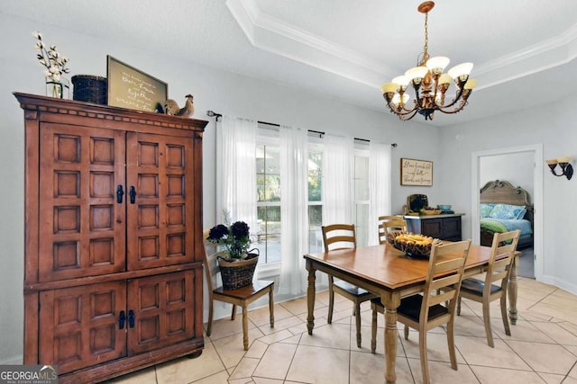 dining area featuring a tray ceiling, light tile patterned flooring, ornamental molding, and an inviting chandelier