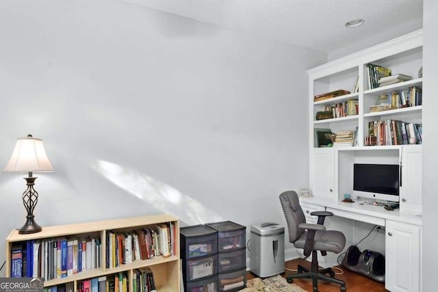 office with hardwood / wood-style floors and a textured ceiling