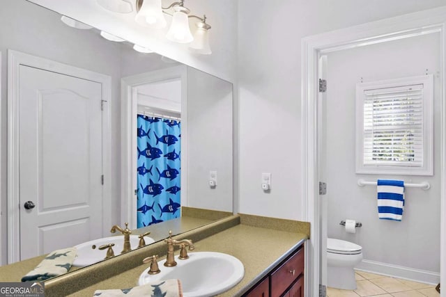 bathroom with tile patterned floors, vanity, and toilet