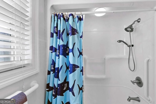 bathroom with shower / bath combo with shower curtain