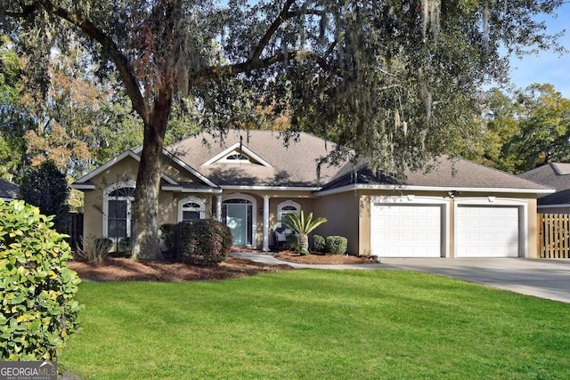 single story home featuring a garage and a front lawn