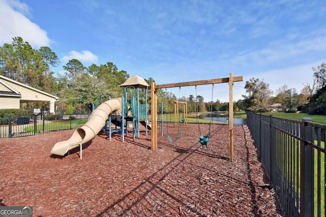 view of playground with a water view