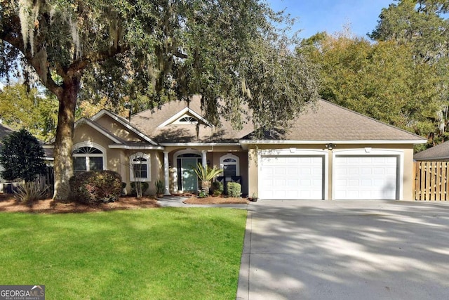 view of front of property with a garage and a front lawn