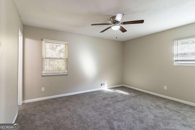 empty room featuring carpet flooring, ceiling fan, and a healthy amount of sunlight