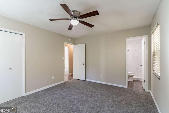 unfurnished bedroom with ensuite bath, ceiling fan, a closet, and carpet floors