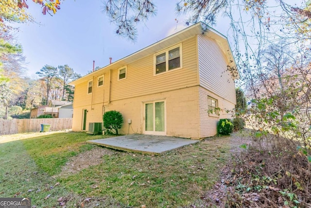 back of property featuring a yard, central AC unit, and a patio area