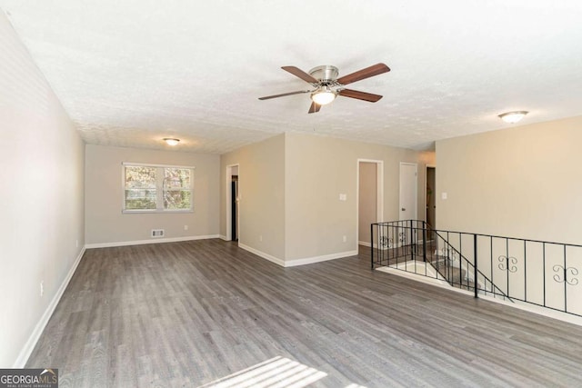 spare room featuring wood-type flooring, a textured ceiling, and ceiling fan