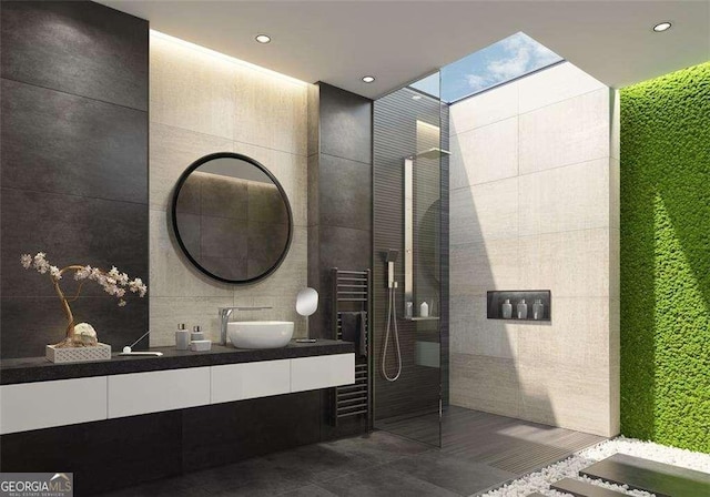 bathroom with walk in shower, vanity, tile patterned floors, and tile walls