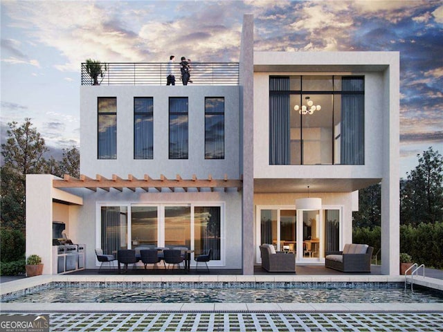 back house at dusk with outdoor lounge area