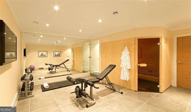 exercise area featuring tile patterned floors and crown molding