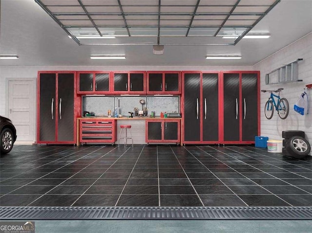 garage with a workshop area and wine cooler