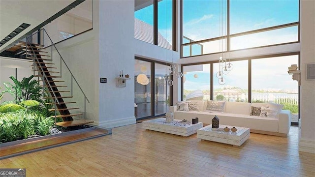 living room with hardwood / wood-style floors and a high ceiling