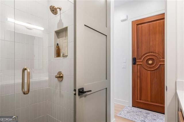 bathroom featuring vanity and an enclosed shower