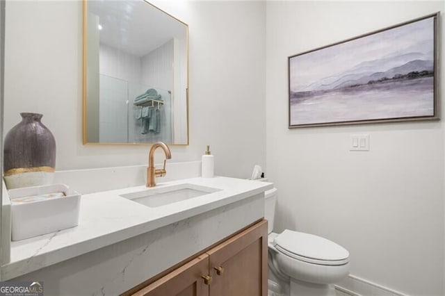 bathroom with vanity, toilet, and a shower with door