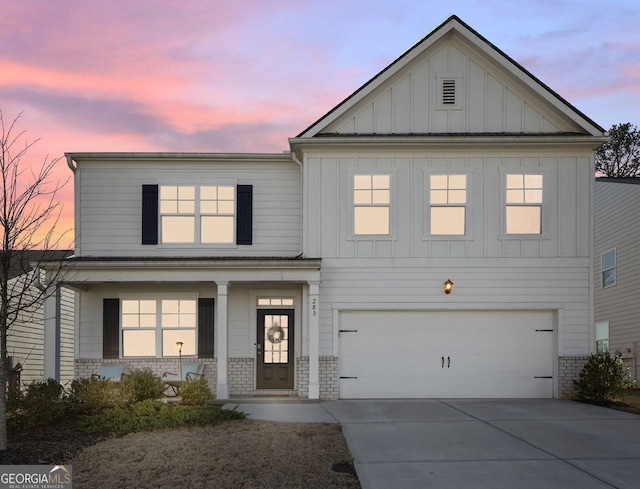 view of front facade featuring covered porch and a garage