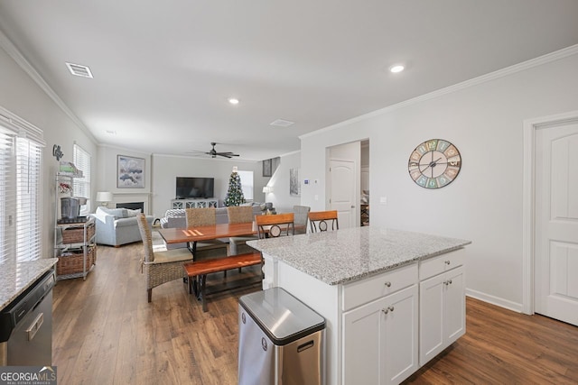 kitchen with white cabinets, a wealth of natural light, a center island, and ceiling fan