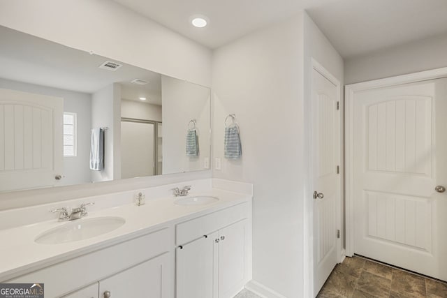 bathroom featuring vanity and a shower with door