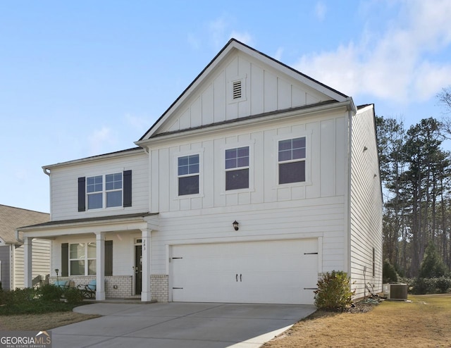 view of front of home featuring central air condition unit, covered porch, and a garage